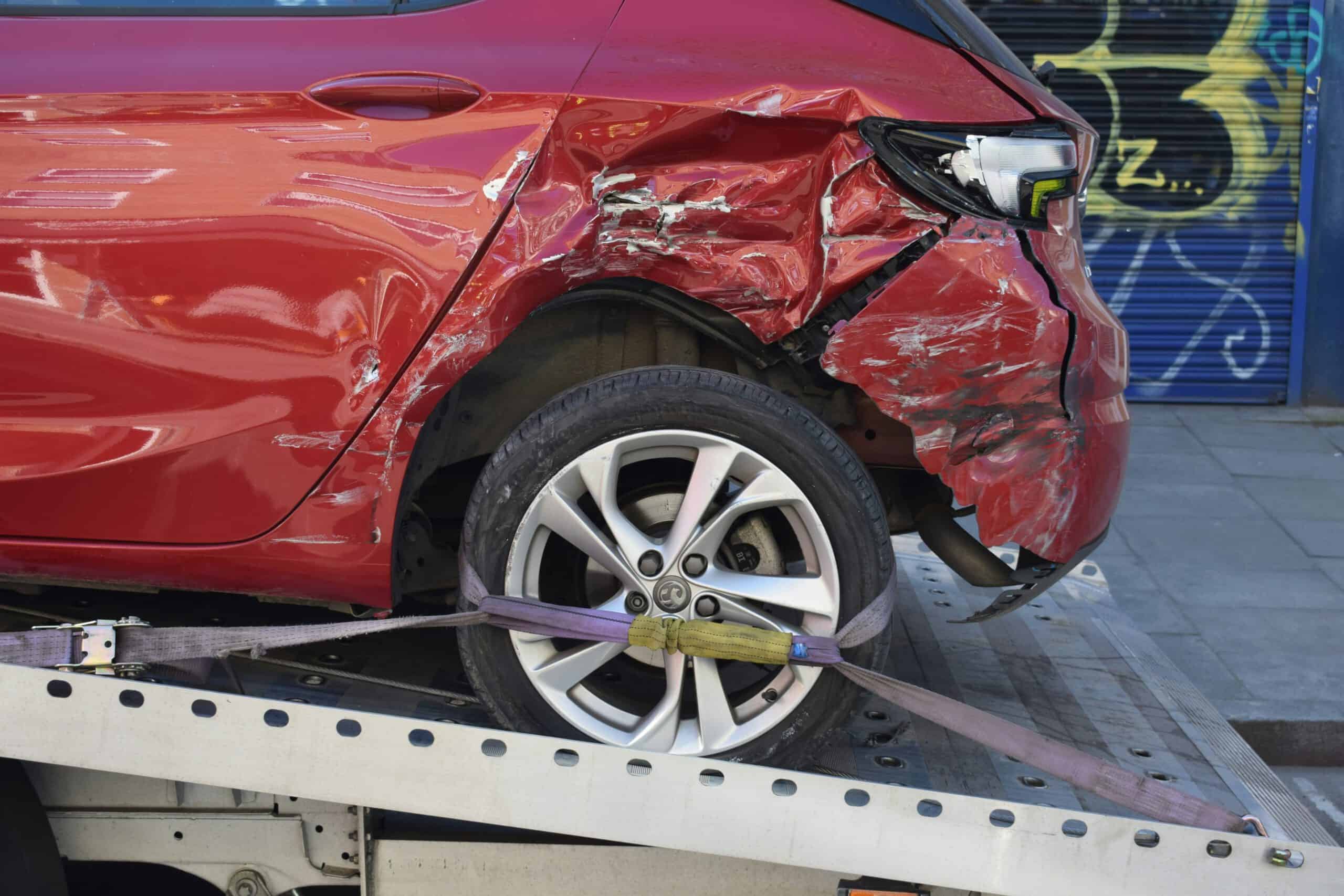 car-crash-insurance-claim image of a crashed red car on the rear side