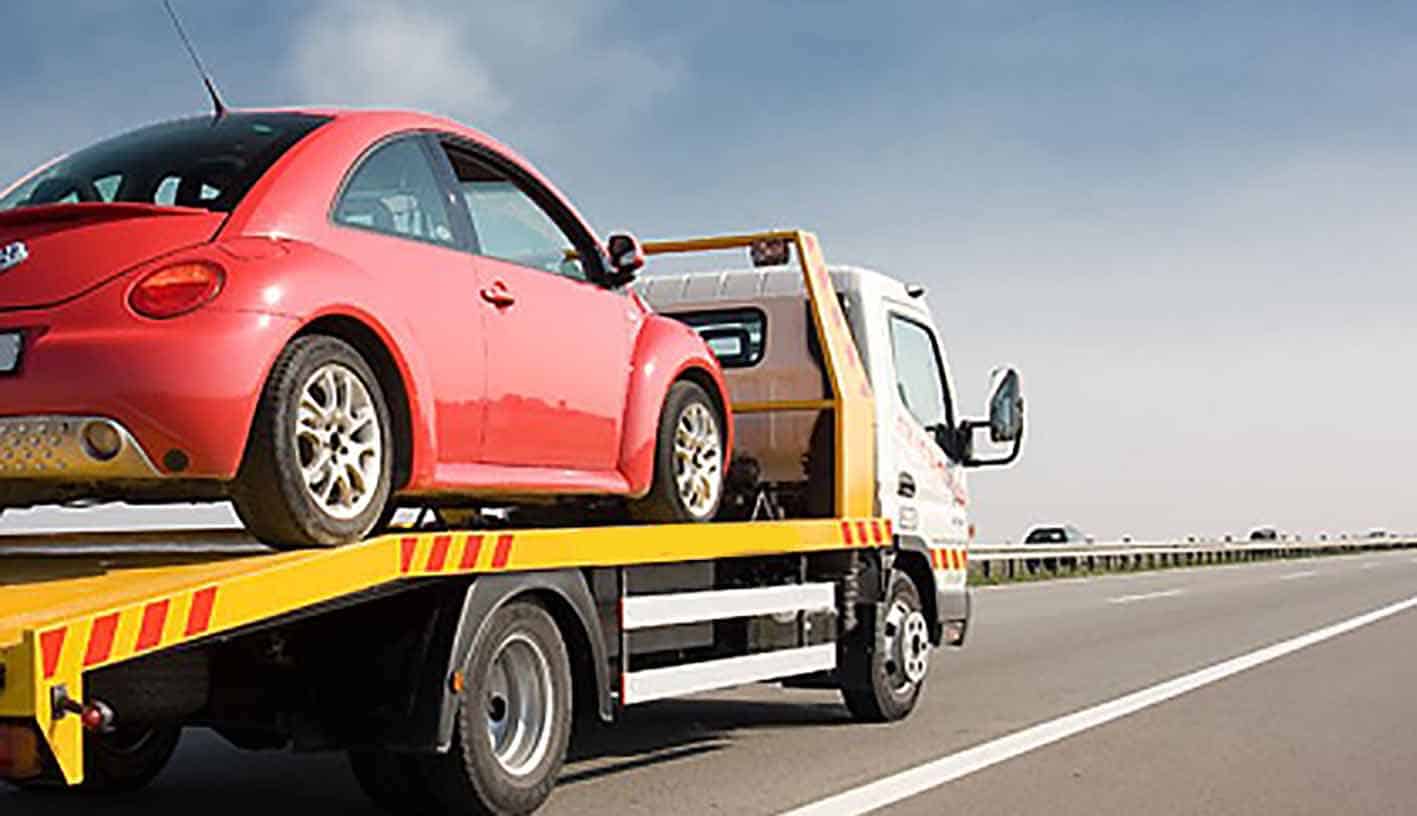 towtruck towing a car image of a tow truck towing a red beetle car