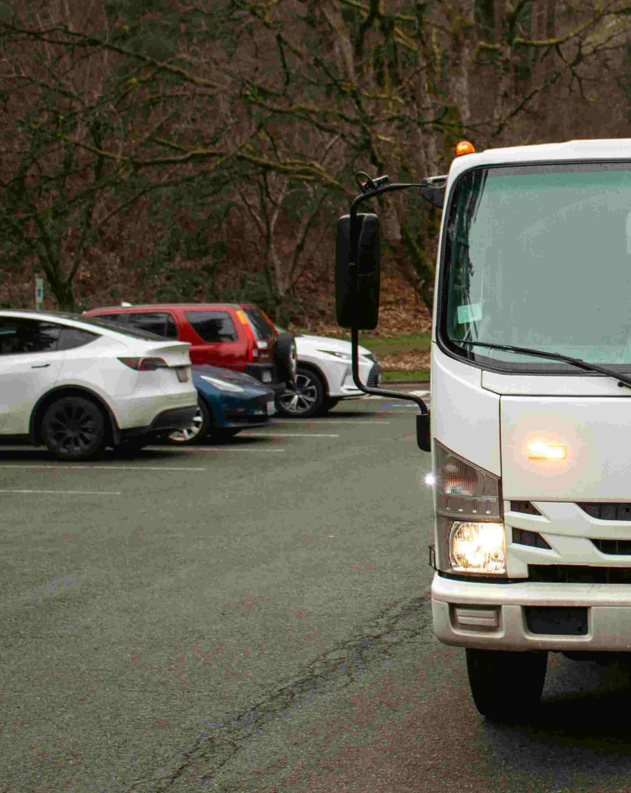white-tow-truck-on-the-road image of white tow truck on the road